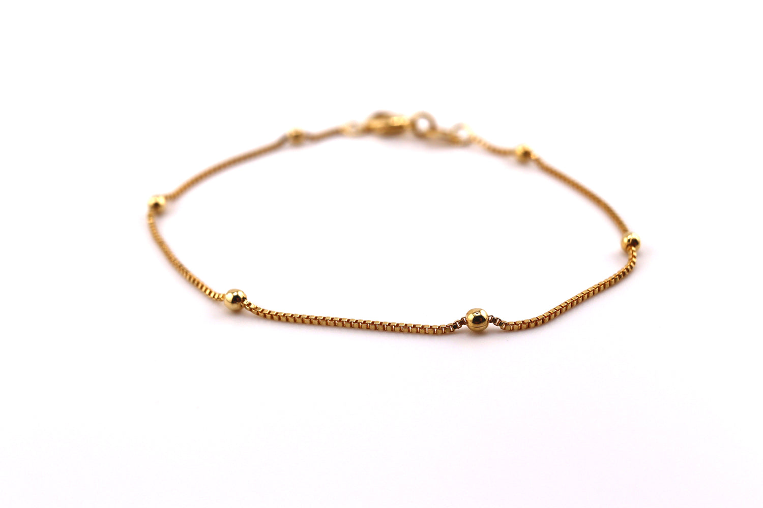 Gold bracelet with bead accents